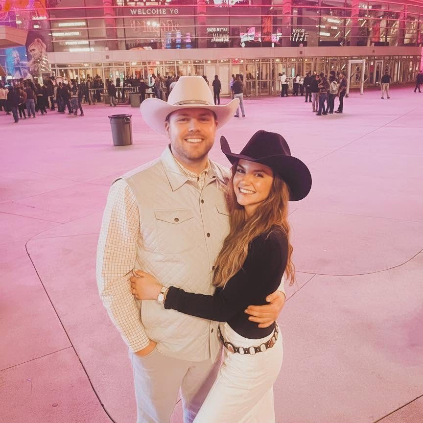 Andrew and Madison in cowboy hats at a concert